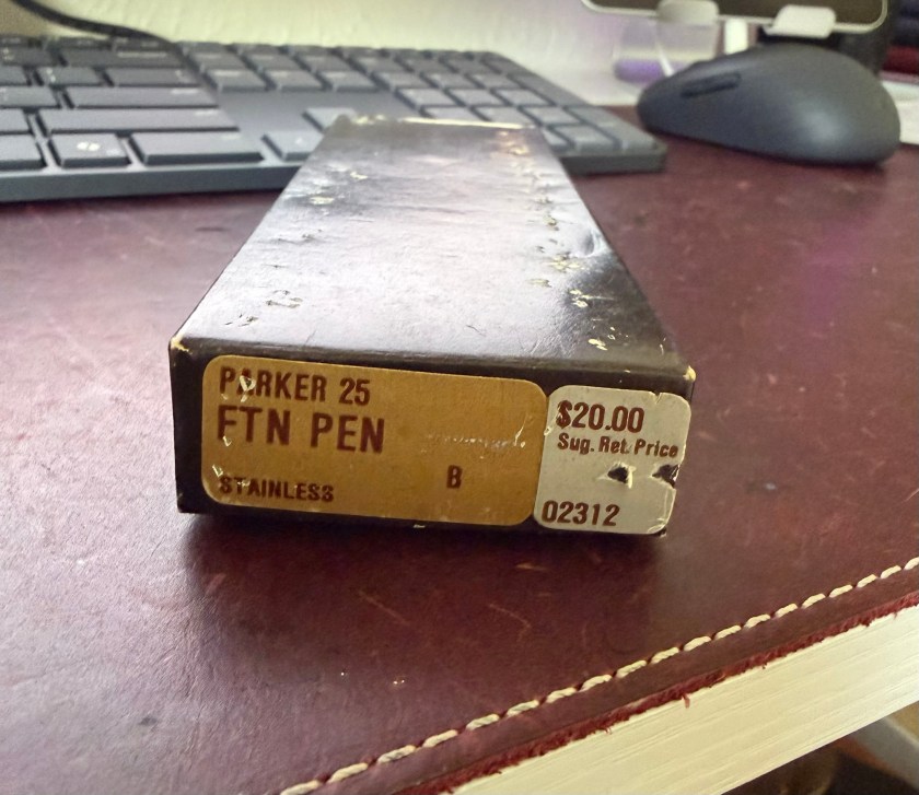 Image of the side of the brown Parker 25 box that has stickers indicating the type of pen, nib size and suggested retail price